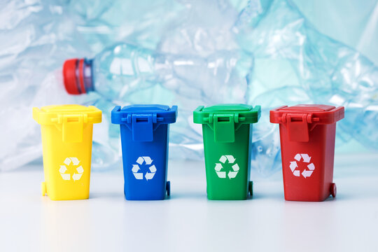 Garbage cans on polyethylene, lastic bottles background. Recycle concept