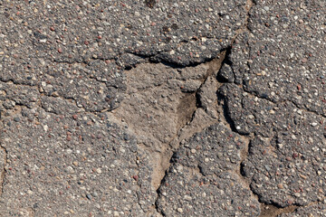 paved road with a lot of holes