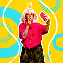 Young beautiful woman in retro-style clothes painting lips with lipstick. Patterned background.