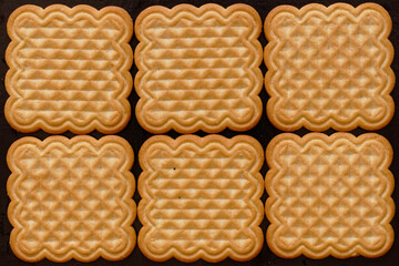 Six biscuits on black background