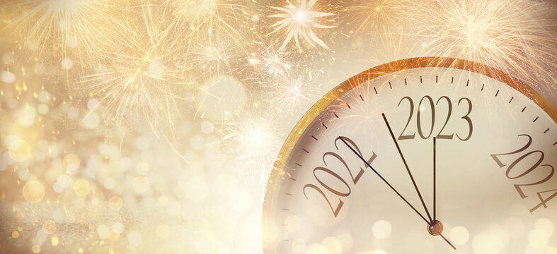 Clock counting last moments to New 2023 Year and beautiful fireworks on background, banner design