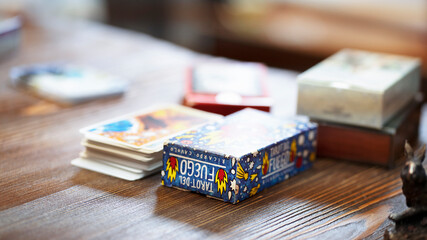 Fototapeta premium Blurred Tarot cards on the table, esoteric concept, fortune telling and predictions