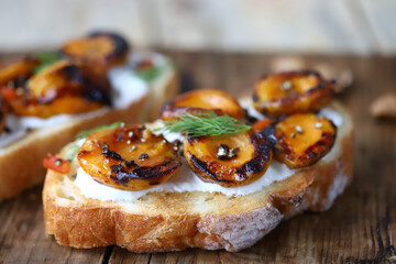 Sandwiches with dried apricots and white cheese. Healthy snack with apricot. Summer bruschetta with...