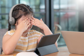 Asian girl covered her eyes from digital eye strain, girl used tablets too much to cause eye...