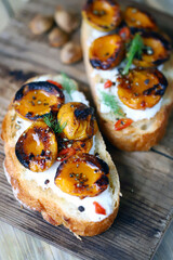 Sandwiches with dried apricots and white cheese. Healthy snack with apricot. Summer bruschetta with apricots.