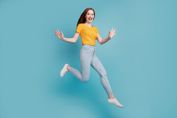 Portrait of carefree energetic lady jump run have fun on blue background