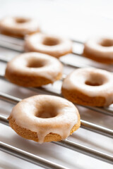 Home made baked whole wheat vegan donuts with orange glaze