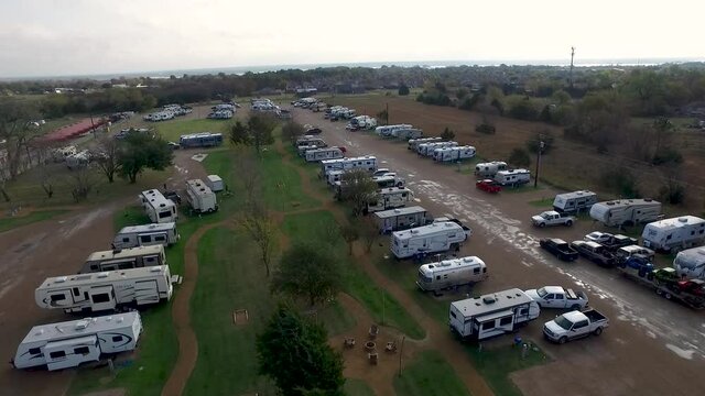 Aerial shot of of an RV Park with many vehicles 2. Drone video of the RV parking zone near the vehicle camping.