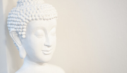 White buddha statue with closed eyes