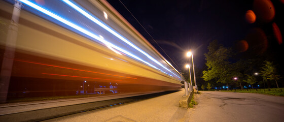 Blurred fast moving tram at night