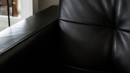 Part of black leather sofa