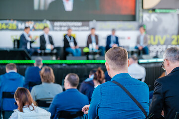 Participants of open air conference listening to speaker