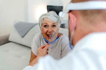 Caucasian female patient visiting her doctor's office and getting tested for COVID-19 by her doctor...
