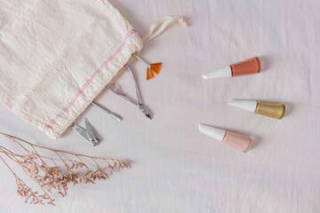 Lifestyle flat lay, top view, composition with nail polish, cotton bag and manicure tools. Beauty...