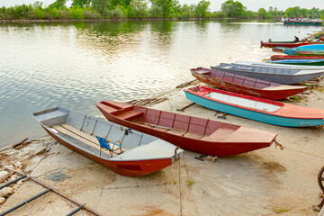 Fototapeta na wymiar Metal fishing boats are dry docked above water