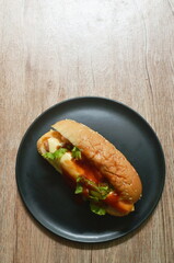 hot dog stuffed smoky pork sausage and slice cheese with lettuce dressing ketchup on dish