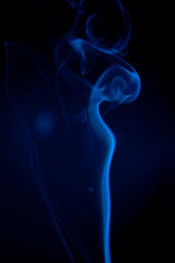 Blue smoke on black background.