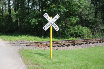 railroad crossing sign with yellow pole