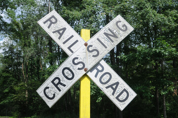 railroad crossing sign with yellow pole