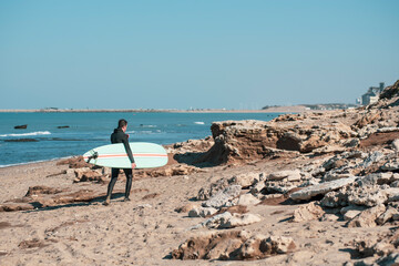 surfing walking on the beach coast