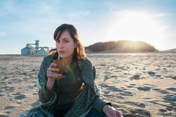 woman on the beach drinking mate