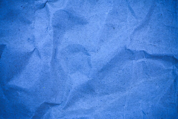 Textured crumpled packaging blue paper background.