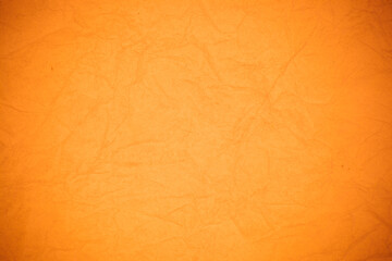 Crumpled orange paper background.