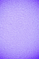 Water bubble on mauve glass.