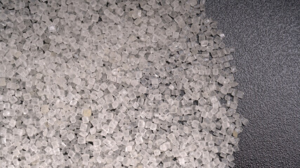 Sugar in glass bowl on wooden background.