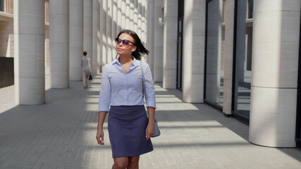 African businesswoman walk near office building