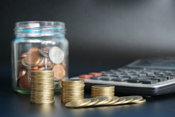 stacks of money coin with calculator, Business and financial investment concept blur background