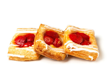 Puff pastry pies with strawberries on a White background. Puff pastry filled.