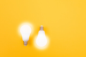 A Power Saving Lamps on Yellow Background - Top View