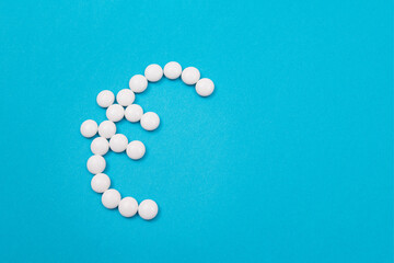 Global Pharmaceutical Industry and Medicine Business - Euro Symbol Made from White Pills Lying on Blue Background