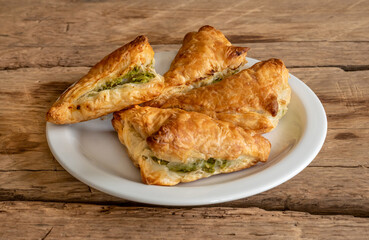Pies filo pastry with chicken and spinach on the wood deck.