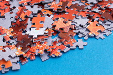 Mixed Peaces of a Colorful Jigsaw Puzzle Lie on the Blue Background - Strategy and Solving Problem Concept