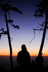 Silhouette women in the dawn of sunset