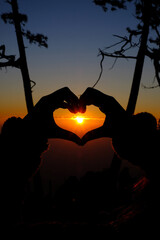 sunrise in the heart shaped hands