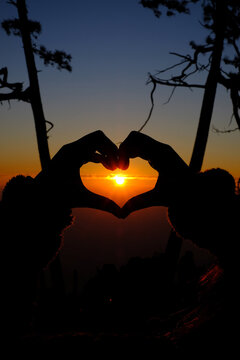 sunrise in the heart shaped hands