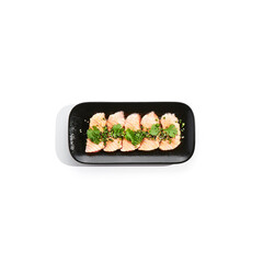 Salmon tataki - seared salmon, thinly sliced sashimi style. Salmon tataki served with delicious citrus ponzu tataki sauce and fresh greens. Japanese seafood on black plate isolated on white