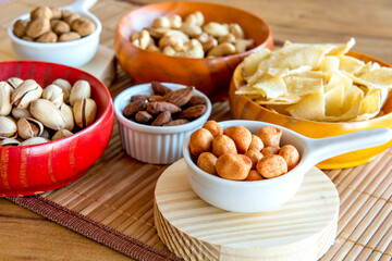 Healthy snack, beans, cassava chips, pistachios, Brazil nuts, chickpeas, peanuts and almonds.