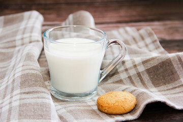 white milk in a glass mug and shortbread cookies