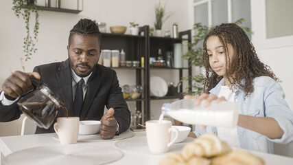 Black family of father and daughter having breakfast, family togetherness