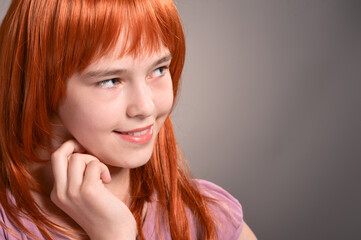 Close up portrait of cute girl with red hair posing