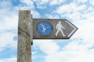 Isle of Anglesey coastal path sign in English and Welsh languages a 130 mile long walking trail...