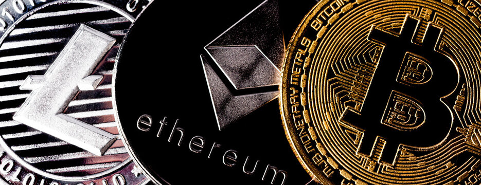 Three physical metal coins - Litcoin, Ethereum and Bitcoin. Cryptocurrency concepts.