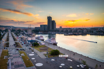 Fototapeta premium Aerial landscape of the harbor with modern architecture and Gdynia city inscription at sunset. Poland.