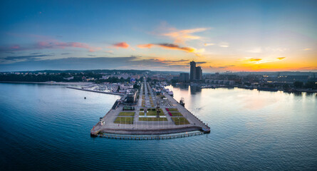 Aerial landscape of the harbor with modern architecture and Gdynia city inscription at sunset....
