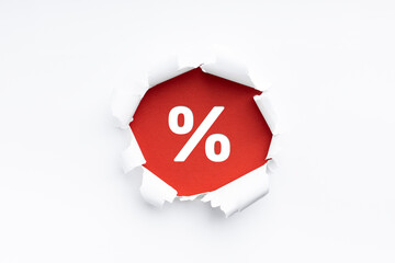 torn paper revealing  a percent sign