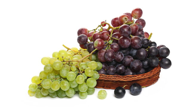 Grapes in wooden wicker basket, isolated on white background
